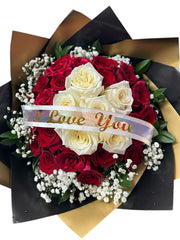 Bouquet of red and white roses with a 'I Love You' ribbon on a black and gold background